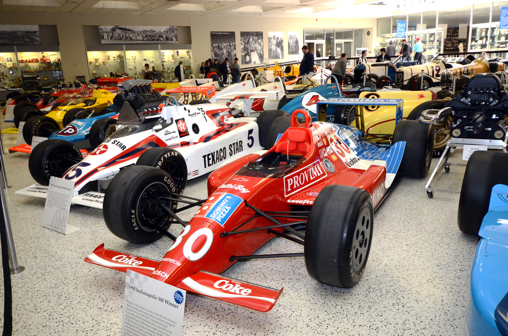 red and white motorcars with large black wheels