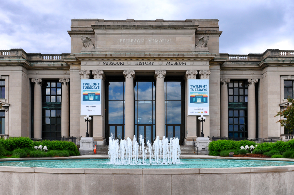 The columned front of the Missouri History Museum with a fountain in front.