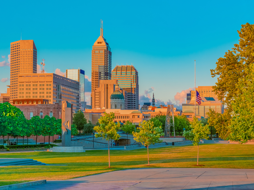 Green lawns of White River State Park with skyscrapers in the background. This fun park is one of the best things to do in Indianapolis.