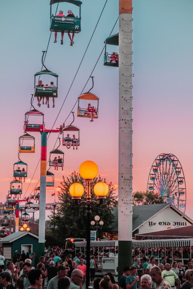 Rides and crowds at sunset at the Iowa State Fair.