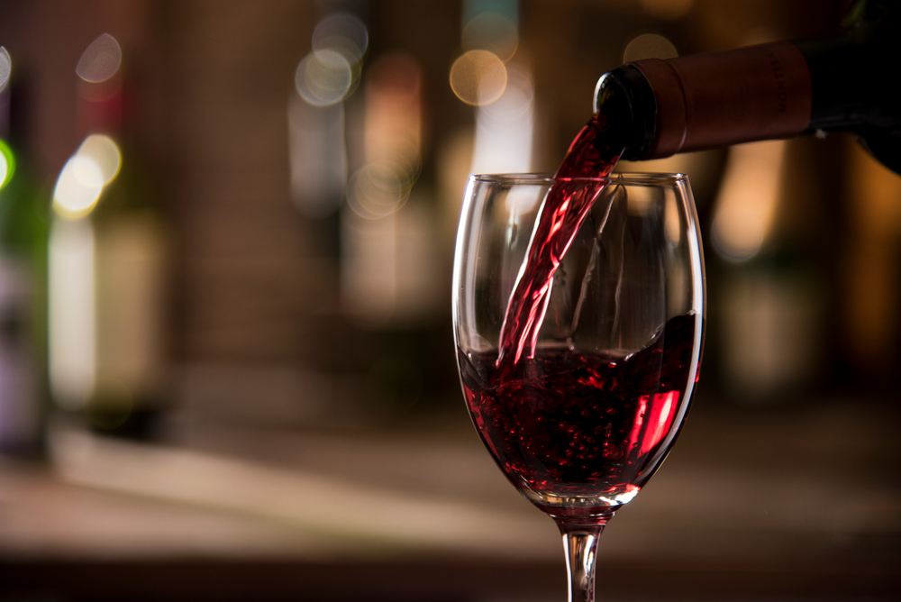 Close up of wine being poured into a glass.