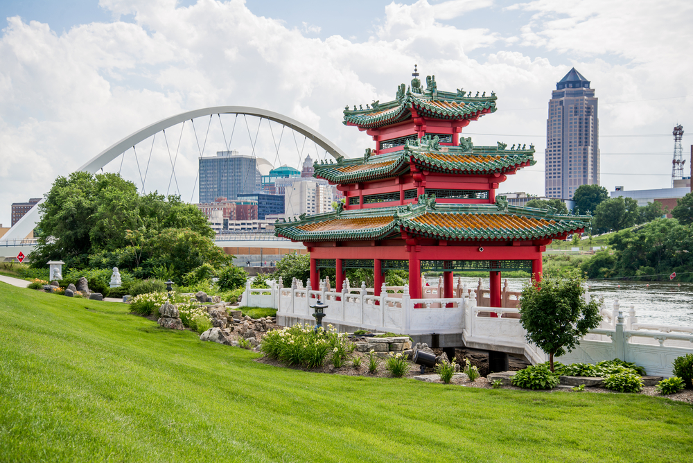 A beautiful, red Asian pavilion standing in front of the Des Moines skyline.