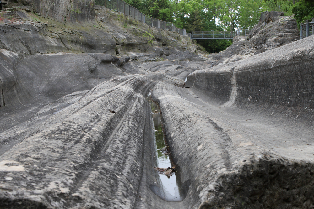 Stone grooves in earth gray in color with green trees and walkways in background. Ohio weekend getaways.