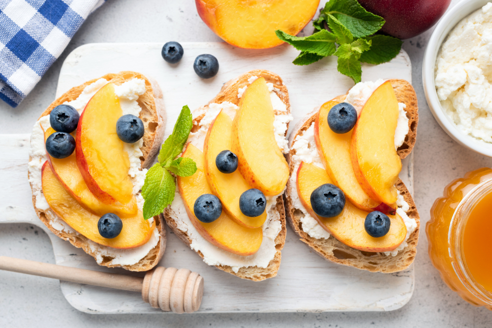 Peach, blueberries and cream cheese on toast in an article about the best breakfast in St Louis