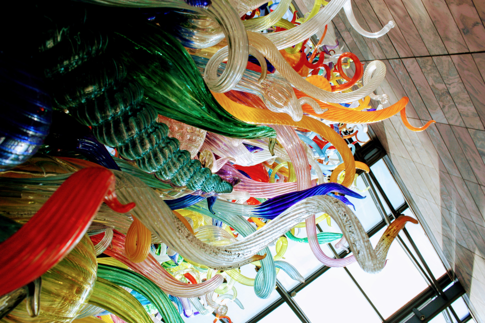 A large multi colored glass sculpture in the Joslyn Art Museum, one of the best things to do in Omaha. The glass is all twisted in different shapes and is both speckled and solid colors.