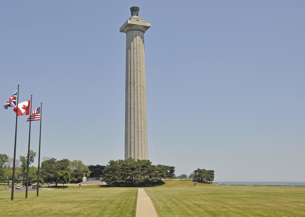 A large monument on a green lawn visiting Perrys Memorial is one of the things to do in Put-in-Bay