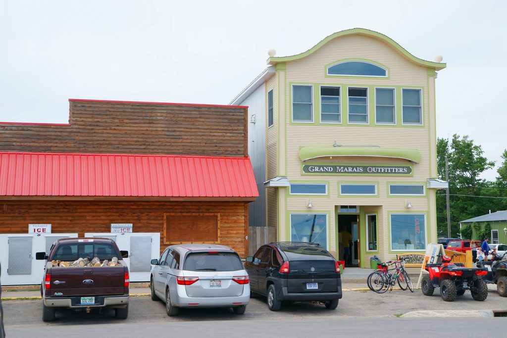 View of attractive business facade. The building is green and cream. The article is about things to do in Grand Marais MN