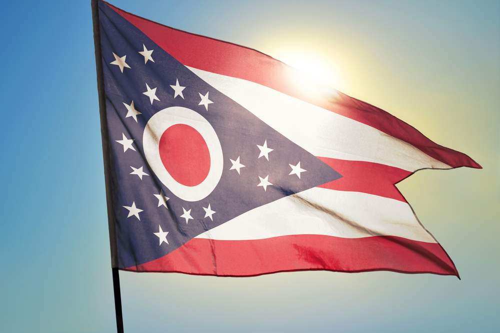 Ohio state flag, red and white stripes and blue triangle with white stars.