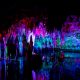Meramec Caverns lit up with colored lights showing stalactites and water