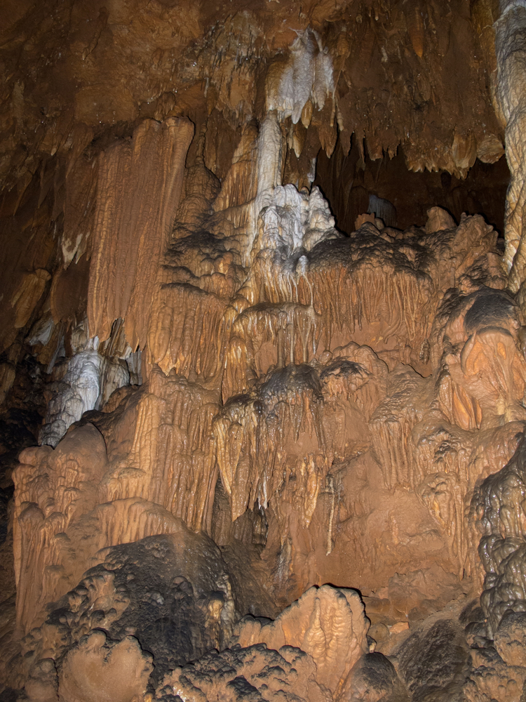 Inside a cave in Missouri showing white deposits and brown rock formations