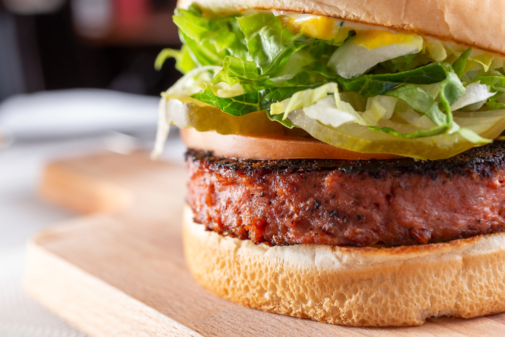 Close up shot of plant based burger with lettuce and tomato. Best Columbus Ohio restaurant.