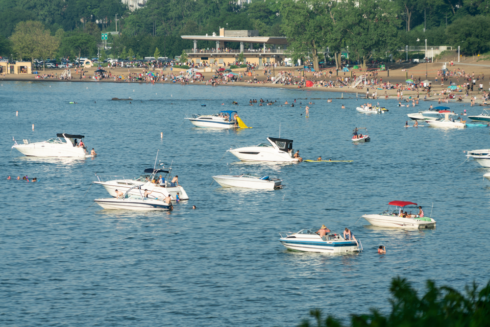 Boats in the lake at Edgewater Park with the beach in the distance.