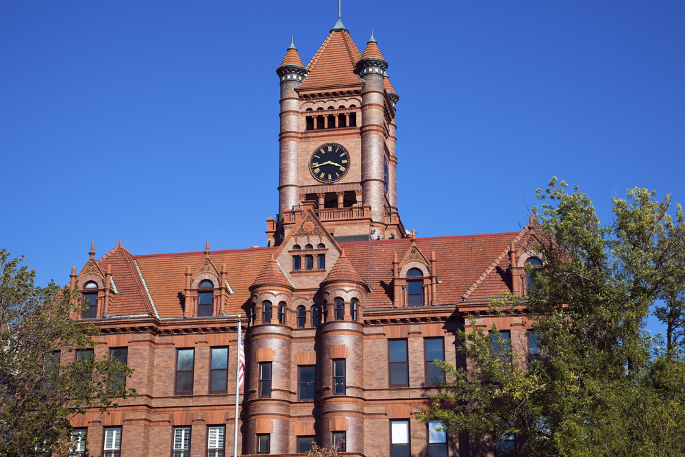 A beautiful, historic building in Wheaton, Illinois, with reddish exterior, turrets and large clock. Small Illinois town.