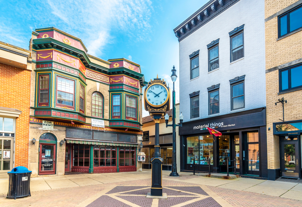 One of the cute small towns in Illinois with vintage buildings in background and clock in forefront