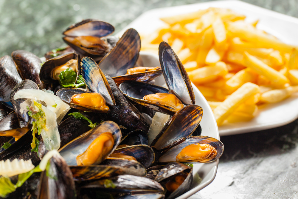 Mussels in a dish with a side of fries in an article about restaurants in Door County