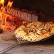A mushroom pizza in a wood fired oven in an article about restaurants in Door County