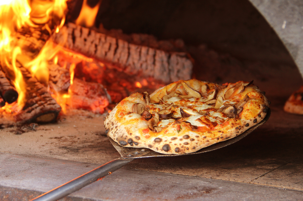 A mushroom pizza in a wood fired oven in an article about restaurants in Door County