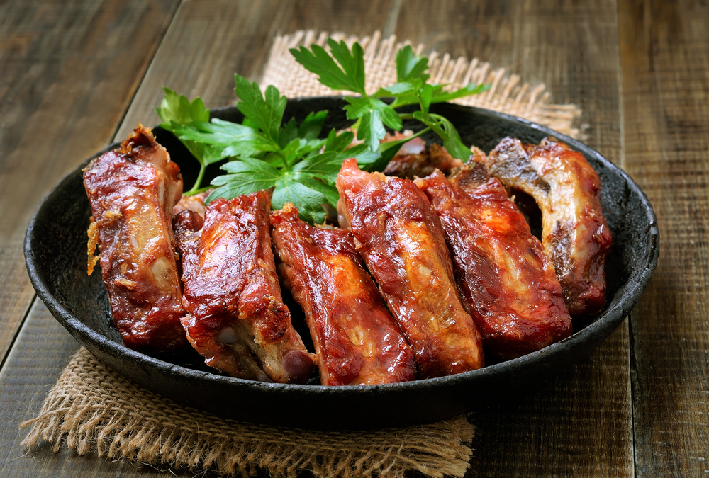 Pork ribs in a grey dish with garnish on top