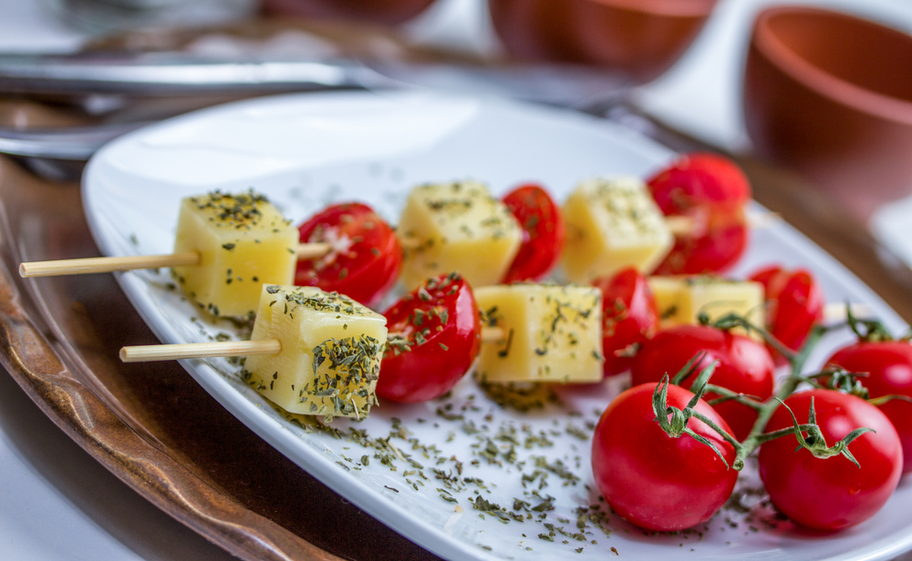 Cheese and tomatoes on a plate with tomatoes on the side. Served at one of the best restaurants in Door County.