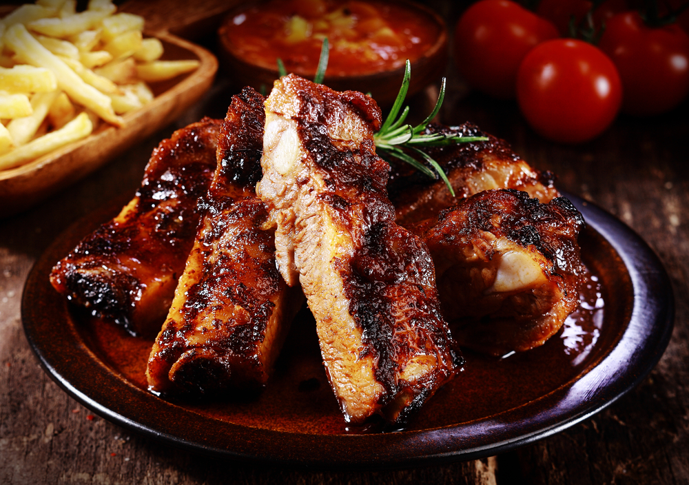 Barbeque meat on a plate with fries on the side in an article about restaurants in Duluth