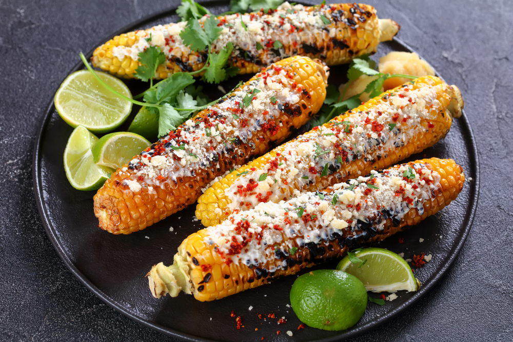 Grilled corn with a sauce on a plate