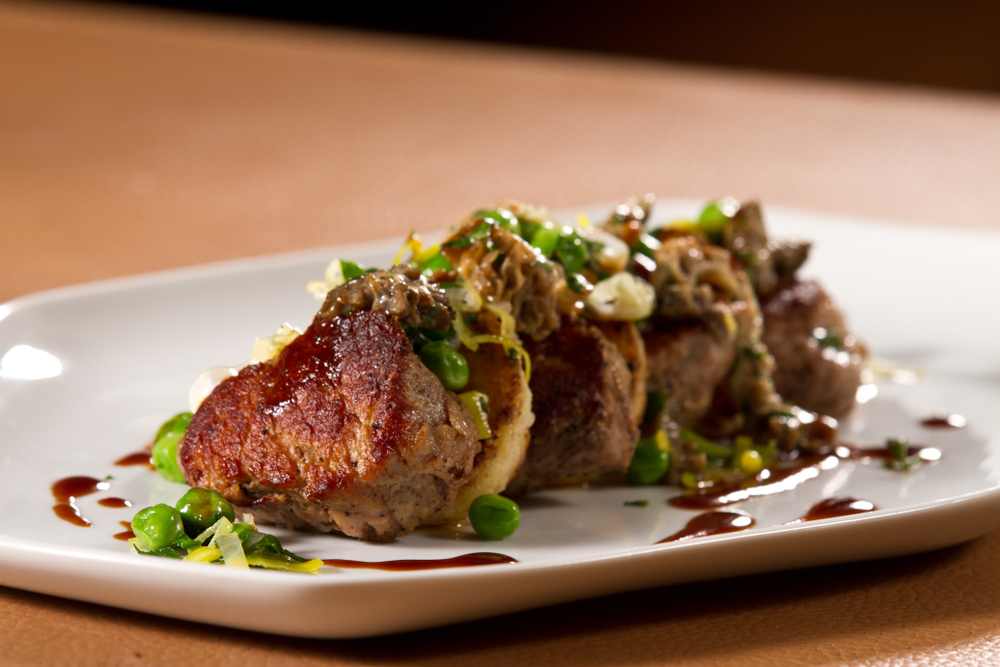 Pork on a plate with peas in a fine dining restaurant