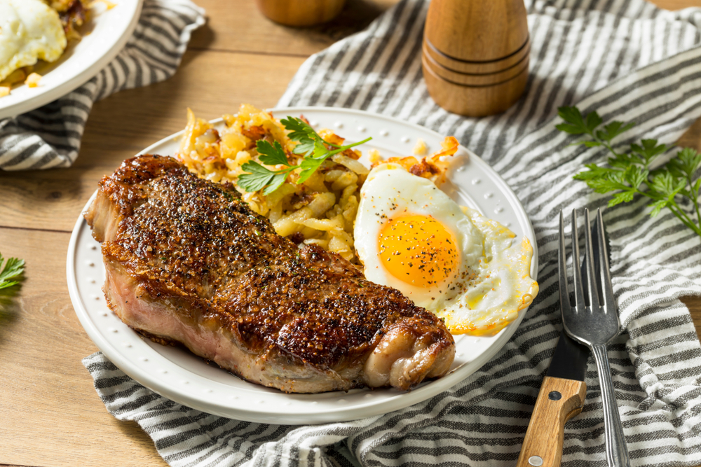 Steak and eggs and potatoes on a plate