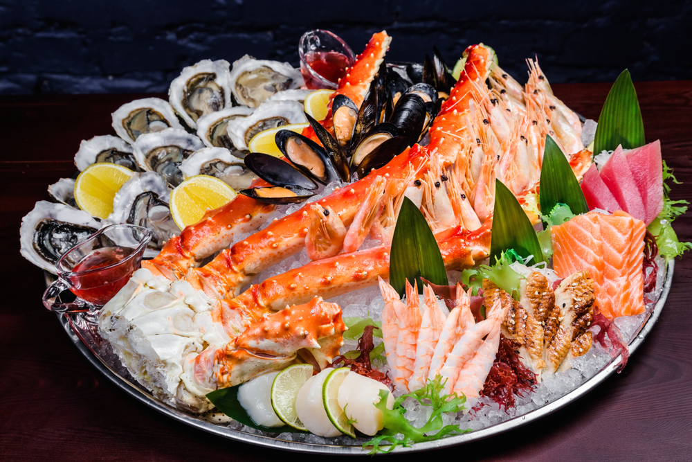 A large seafood platter over ice with mussels, lobsters and other fish