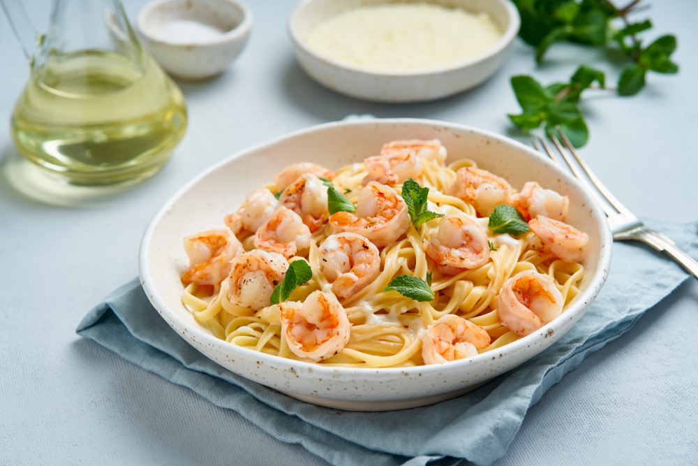 pasta with grilled shrimps in a bowl