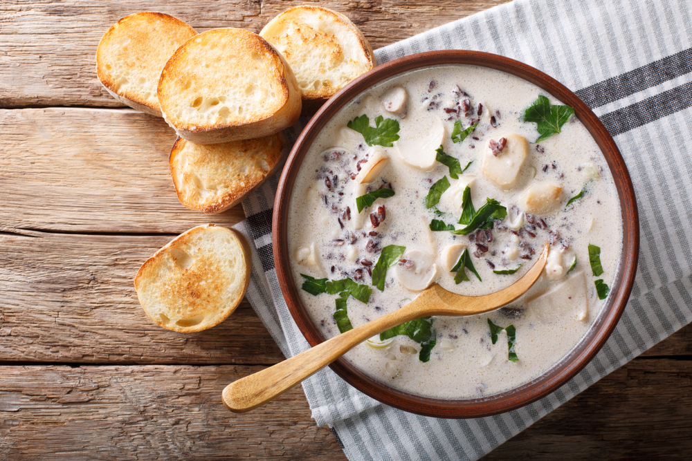 a bould of wild rice soup with bread