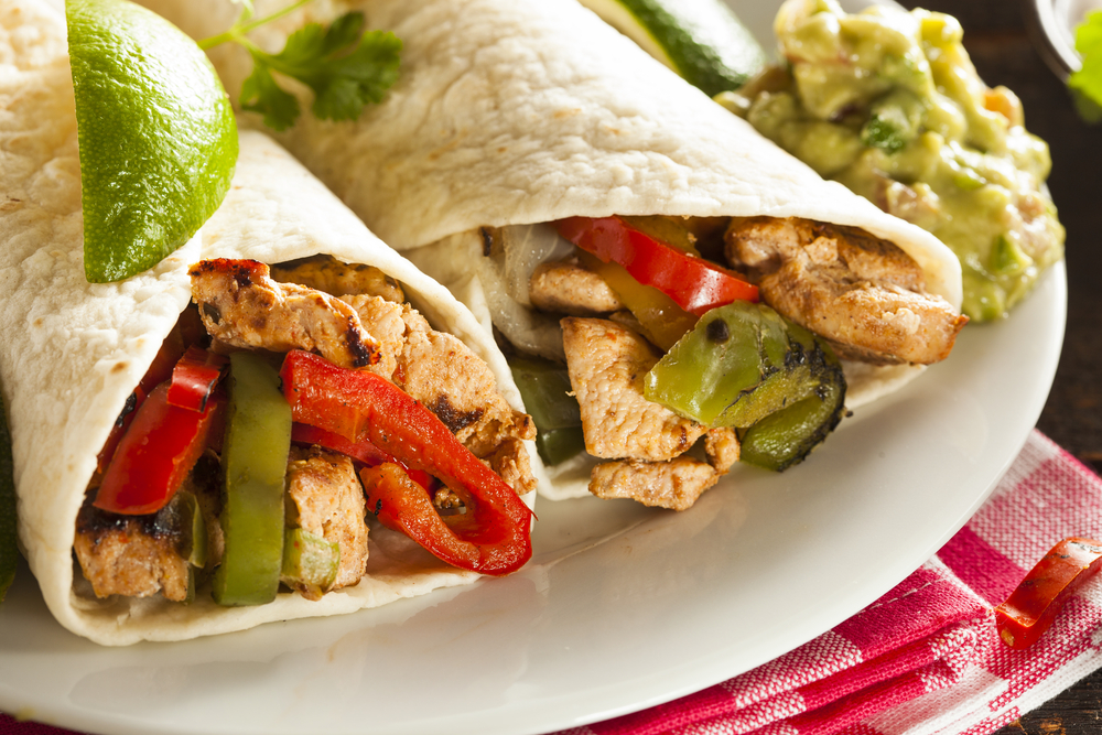 fajitas made from chicken and vegetables on a white plate