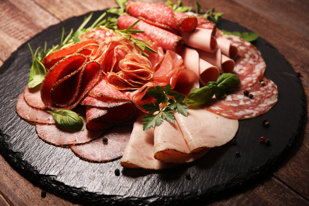 a plate of Italian meats on a grey slate