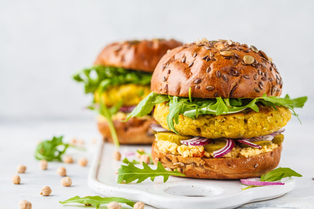 Two Vegan chickpea burger with onions and rocket in an article about restaurants in Toledo