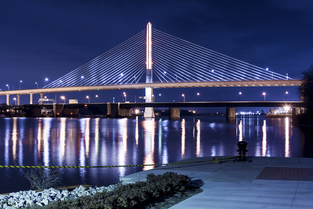 Night view of the Glass city bridge in an article about restaurants in Toledo