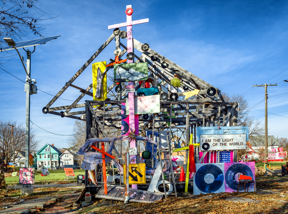 One of the many art installations at the Heidelberg Project. It looks like a house and has signs, painted wood, paintings, and more attached to it. Its one of the best things to do in Detroit. 