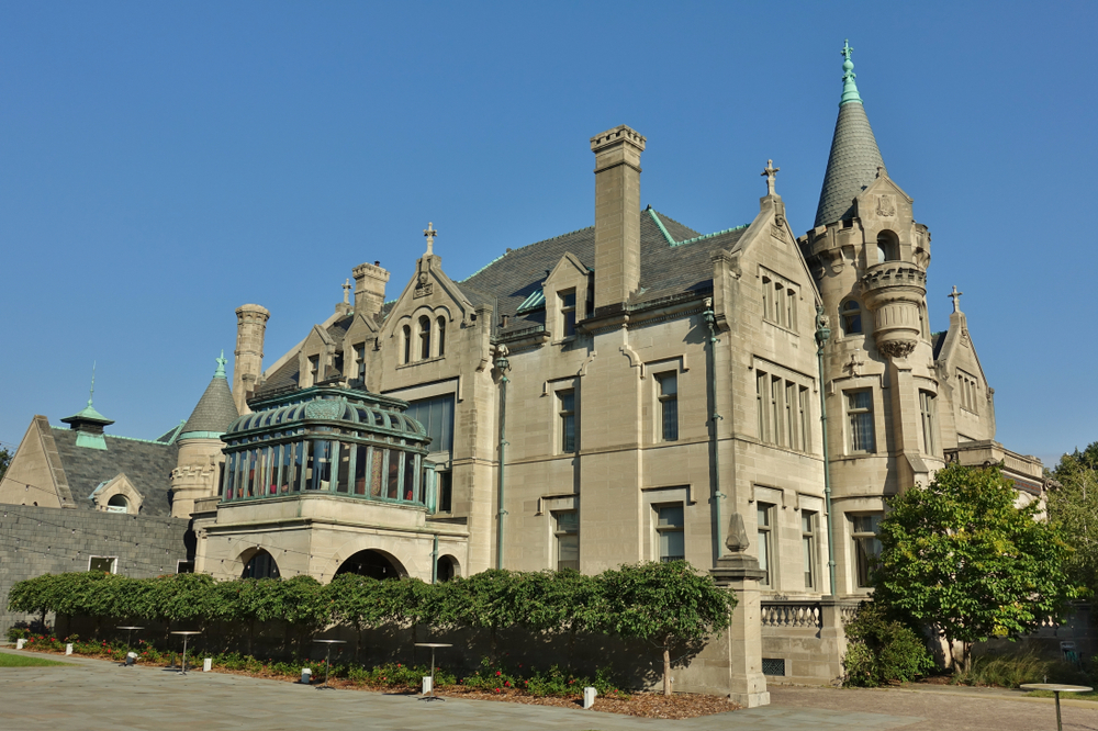 View of the American Swedish Institute (ASI), a museum and cultural center in the Phillips West neighborhood of Minneapolis. A grey brick building with an ornate glass conservatory.