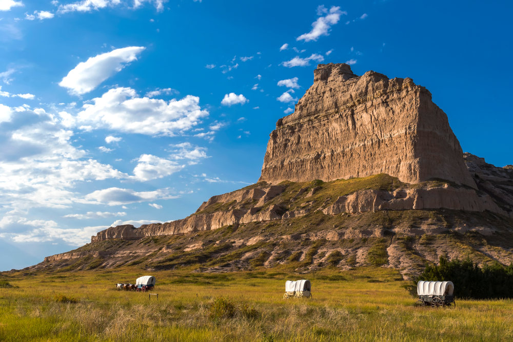 Tall mountain structure with moving carts at the front