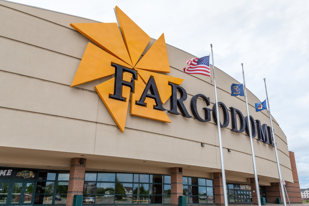a building with fargodome sign and flags flying