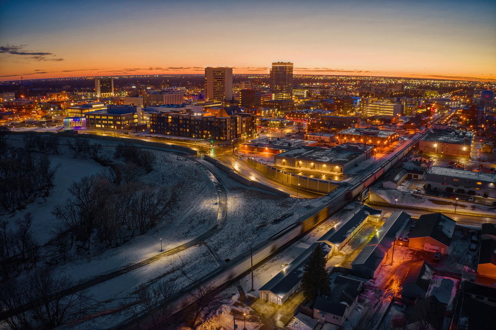 buildings and roads lit up during sunset things to do in fargo