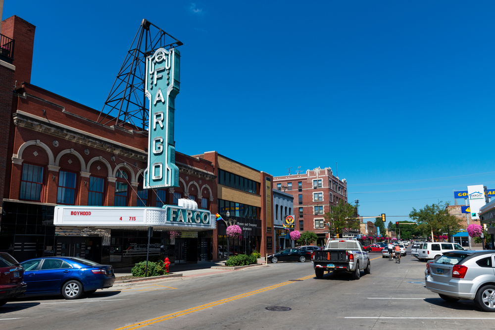 cars moving on the road outside the building of fargo theatre