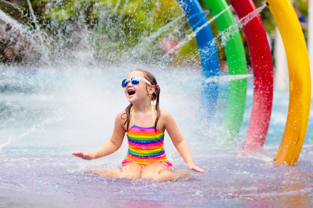 A girl under a spray toy at an Ohio waterpark.
