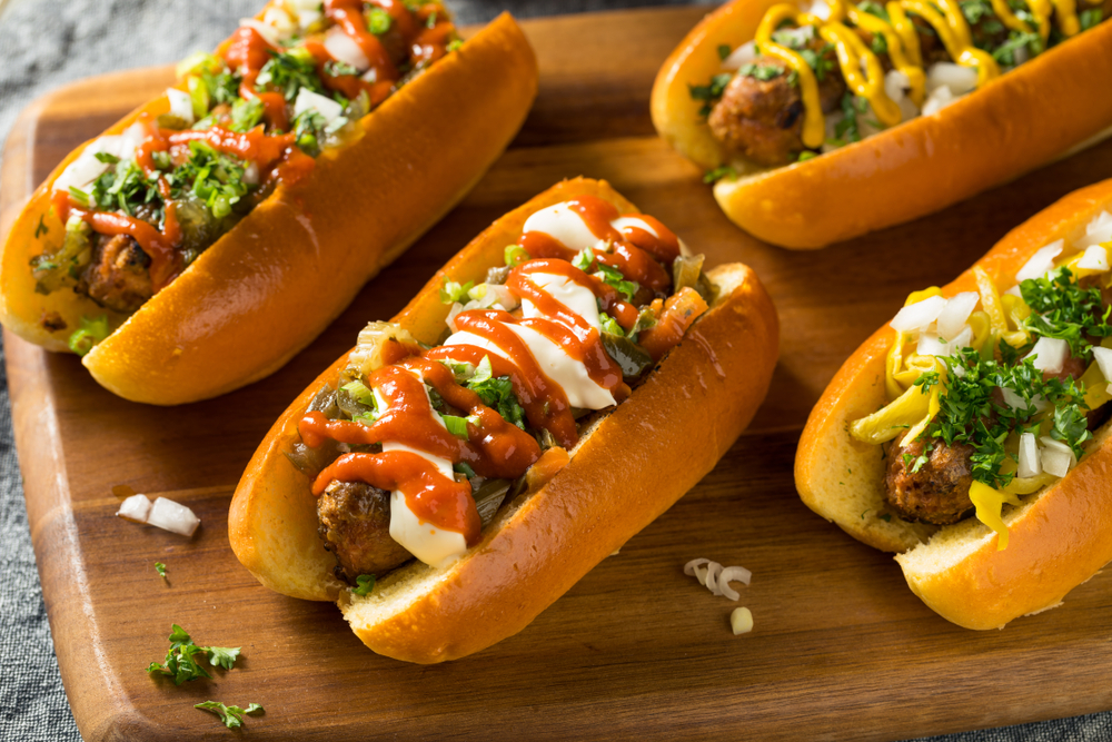 Vegan hotdogs with sauces on on a chopping board in an article about Restaurants in Milwaukee