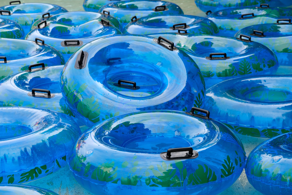 A bunch of blue tubes sitting in water.