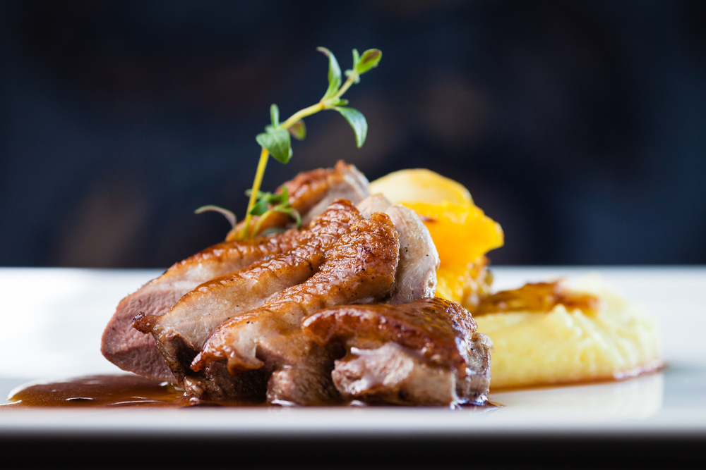 Roast duck with masked potatoes on a plate in an article about restaurants in Kalamazoo