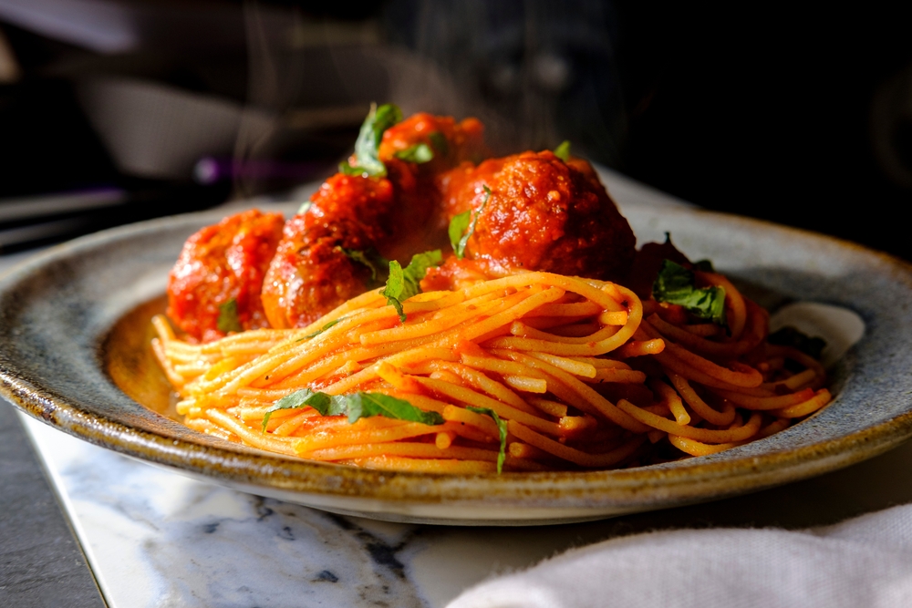 Spaghetti with meatballs and red sauce on a plate in an article about restaurants in Kalamazoo
