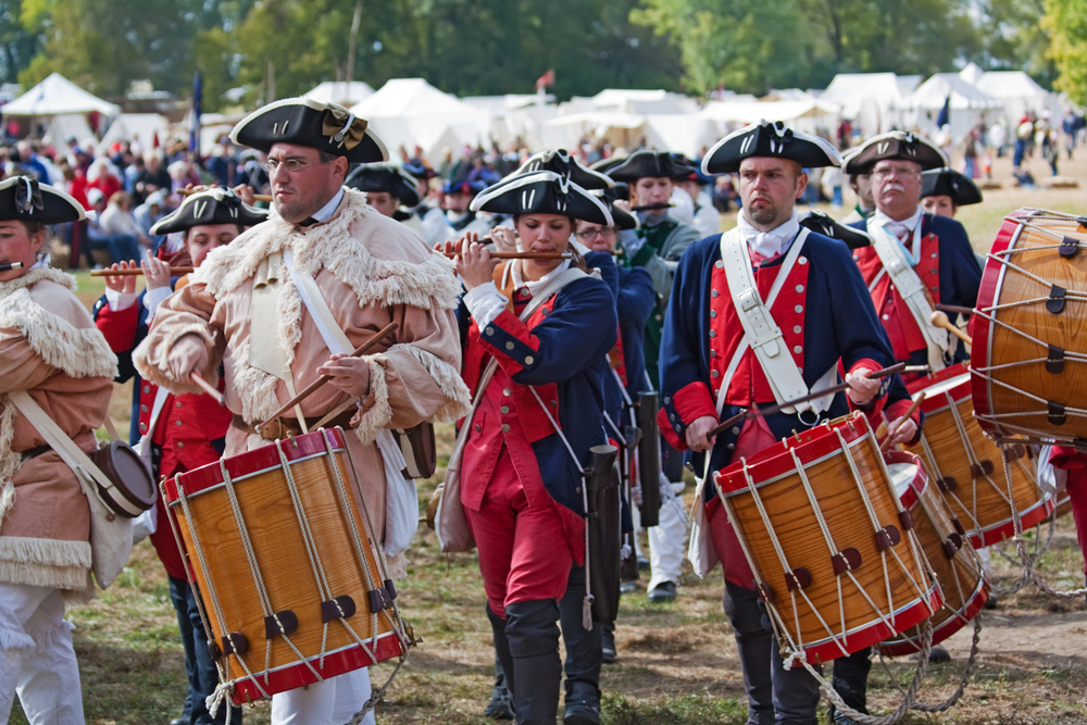 People in costumes playing drums and flutes