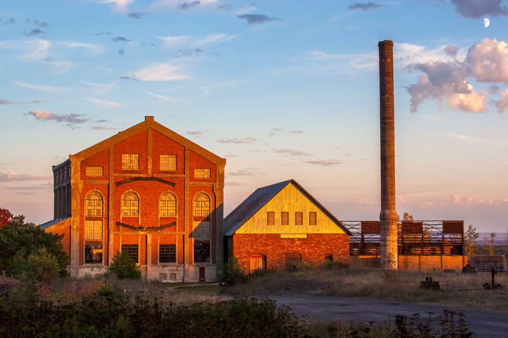 Abandoned mining buildings surrounding by trees