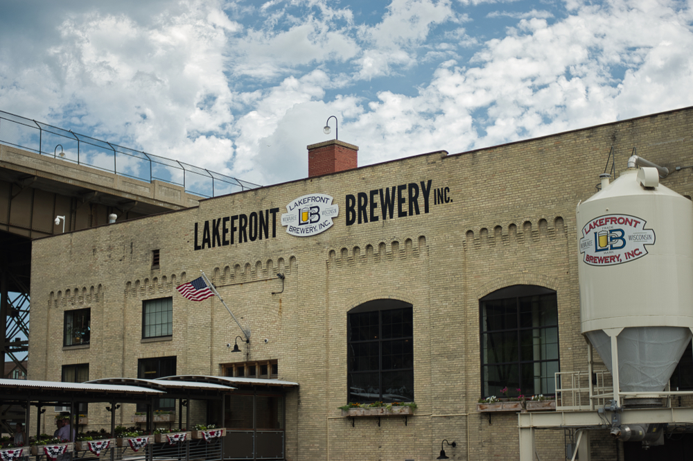 The front of the Lakefront Brewery a cream building with large black windows