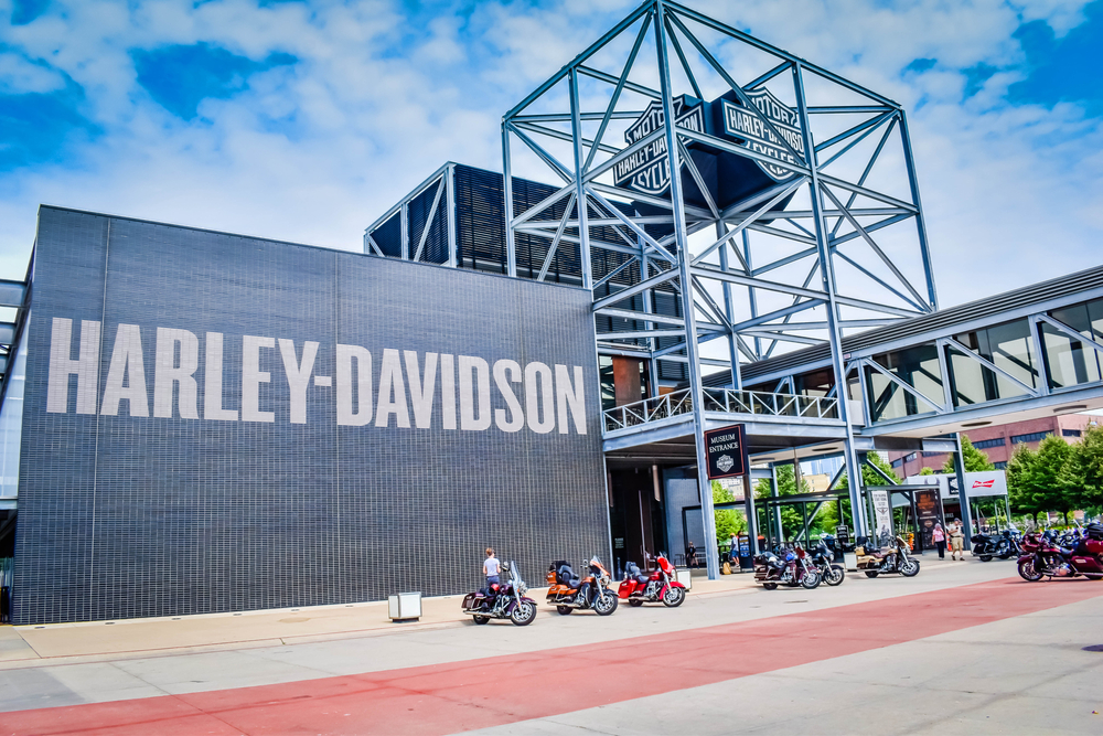 The outside of the Harley-Davidson museum with a large black sign and a metal frame