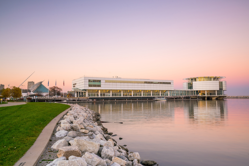 A view of The Discovery World over the lake with the sunsetting behind